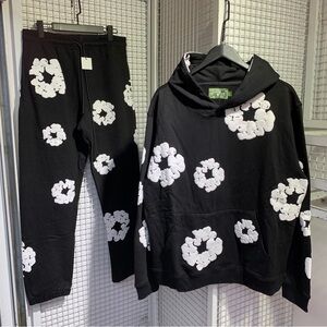 denim tears Stylish Black Hoodie with White Floral Design